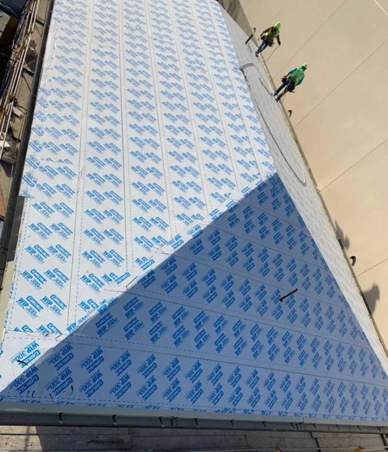 Professional roofers installing underlayment on a metal roof in Willow Park